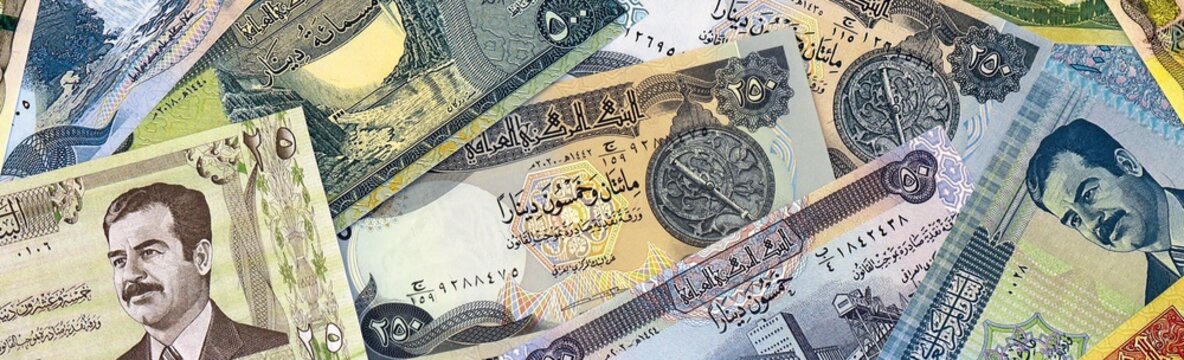 Iraqi dinar money bills in pile on table. Iraq IQD currency cash close up