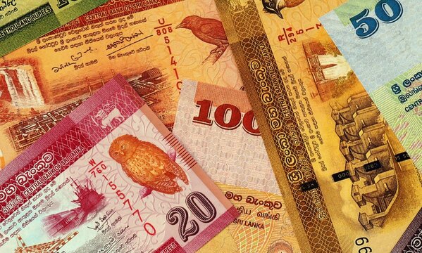 Sri Lankan rupee money bills in pile on table. Sri Lanka LKR currency cash close up