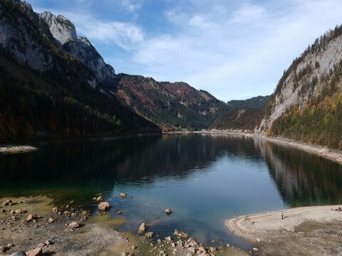 Gosausee Austria drone view with calm alpine lake Dachstein mountains and colourful autumn forest