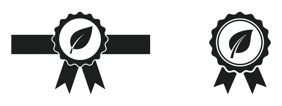 Set of two black eco friendly product quality seal icons with leaf symbols and decorative ribbons