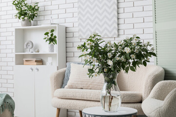 Cozy home interior with fresh jasmine flowers, modern living room decor and comfortable furniture for relaxation © Pixel-Shot