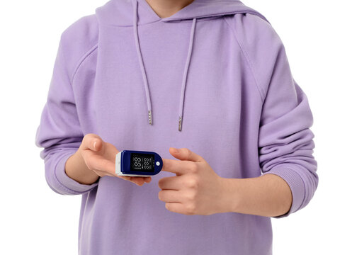 Healthcare monitoring and home health, person using a pulse oximeter on finger for oxygen saturation and heart rate check