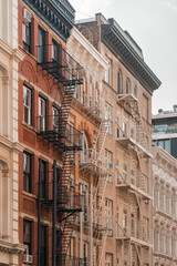 Fototapeta premium Street perspective of architecture in Tribeca Manhattan, New York City. SoHo, Chinatown, Financial District, Little Italy, Nolita