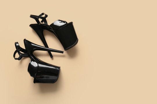 Stylish black high heels for pole dance on color background