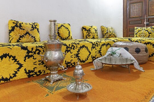 Inviting Moroccan sitting area with elaborate tea set on a decorative tray, Bahia Palace in Marrakech, Morocco