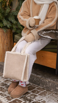 Cozy winter fashion with a warm drink and stylish accessories