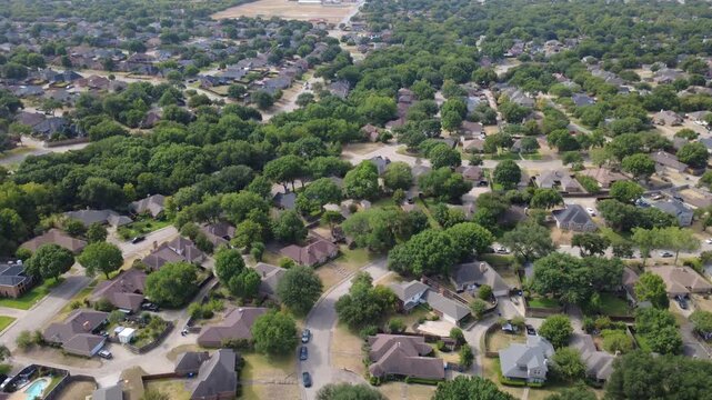 Interconnected residential roadways cross established Meadowbrook subdivisions. Dense clusters of brick homes, parked vehicles, leafy trees border peaceful side streets, DeSoto, TX