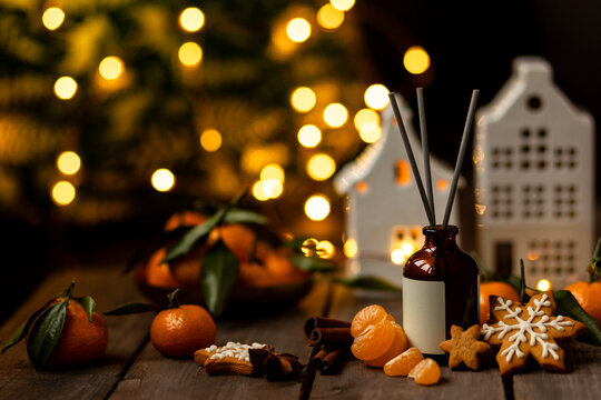 Christmas fragrance with citrus, cinnamon, anise, vanilla, gingerbread cookies. Home comfort, coziness, aromatherapy. Winter time. Cozy interior with aroma perfume diffuser in the living room. 