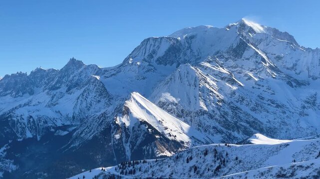 Wide, panoramic shots of the snow-covered peaks of the Mont Blanc Massif under clear blue skies.