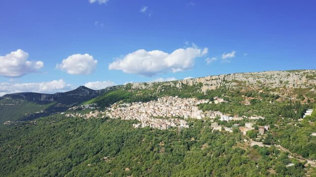 Drone footage showing the picturesque village of Baunei, located in the hills of Sardinia, Italy.