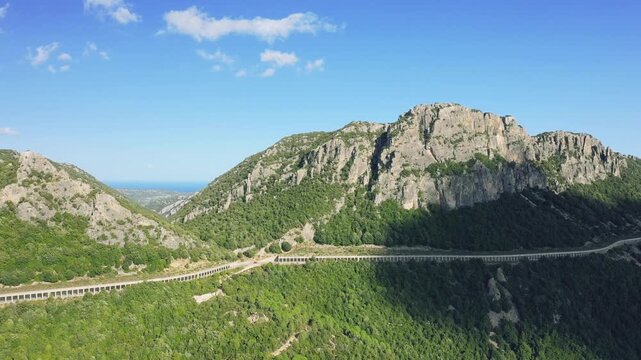Aerial footage showcasing the rugged countryside surrounding Baunei, a town in Sardinia, Italy.