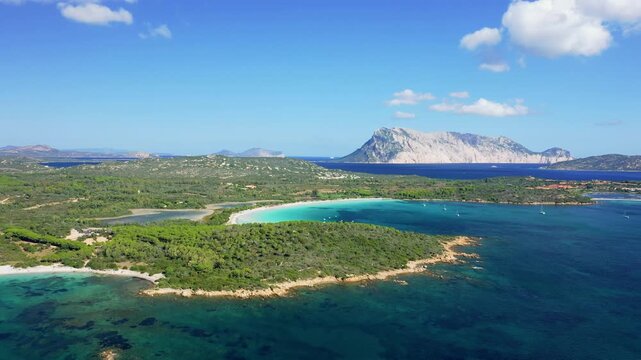 Aerial footage showcasing the stunning Cala Brandinchi beach near San Teodoro, Sardinia, Italy. No people are visible, emphasizing the pristine and tranquil atmosphere of the location.