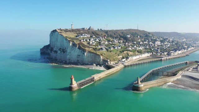 A sweeping aerial shot of the dramatic white chalk cliffs and coastal town of Fecamp in Normandy, France.