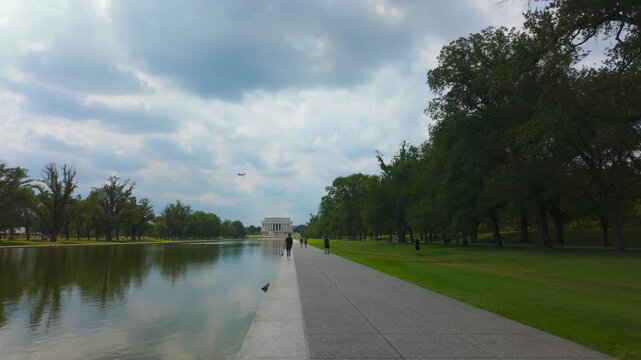 Cinematic Gimbal Walk Along National Mall Reflecting Pool Toward Lincoln Memorial on Sunny Summer Day