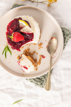 Mini berry cheesecake topped with jam and strawberry