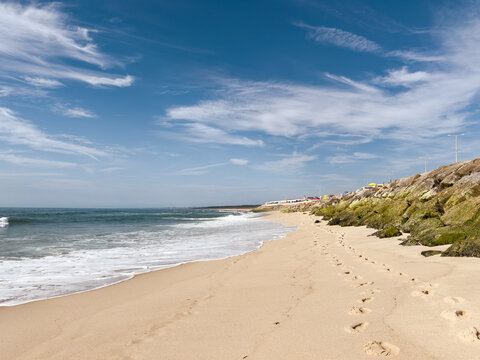 Sandy shore at Praia do Furadouro with rock breakwater
