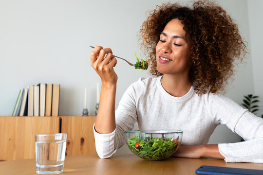 Young woman enjoying healthy fresh salad for diet