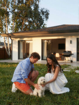 Family Petting Dog in Backyard