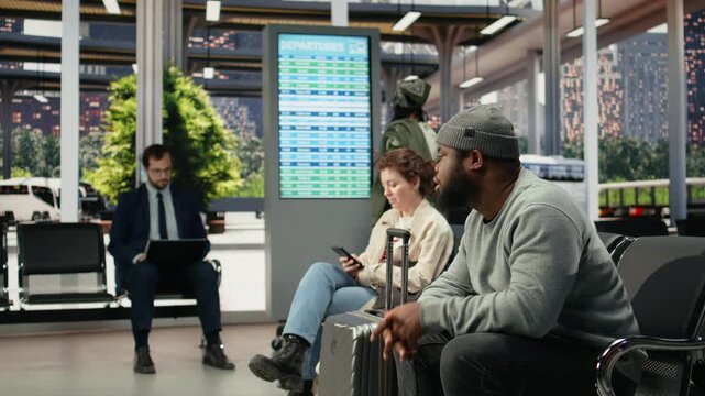 Weary traveler dozes on a bus stop bench during a delayed route, with an exhausted man napping on a chair after slow public transit leaves him tired while waiting for the next connection.