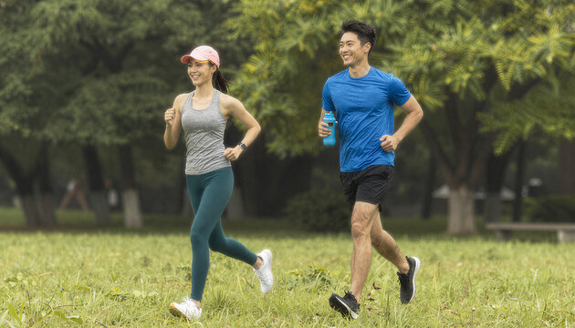 Joyful Couple Jogging in Park