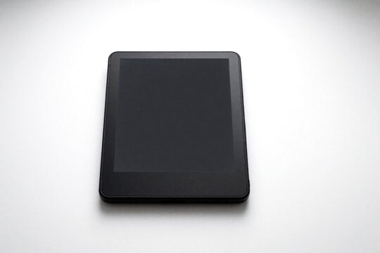 Black ebook reader with blank dark screen on white background. Modern electronic device for digital reading, learning. Minimalist tablet gadget isolated in studio. Portable e-reader hardware for