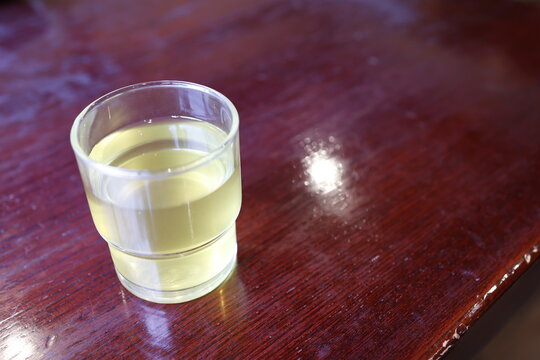 ガラスのコップに入ったそば茶。温かい飲み物。木製テーブル。