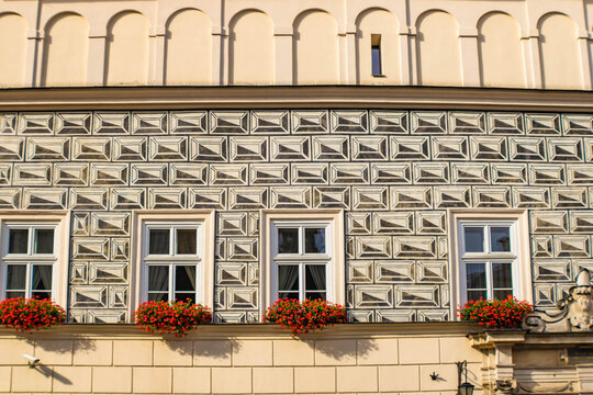 Close up of the sgraffito wall in the Old town, windows with flowers, Krakow, Poland