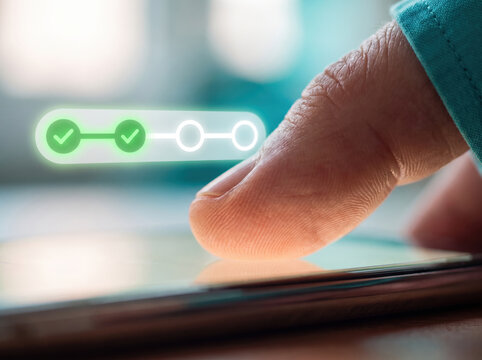 Finger pressing green checkmark app icon on smartphone screen