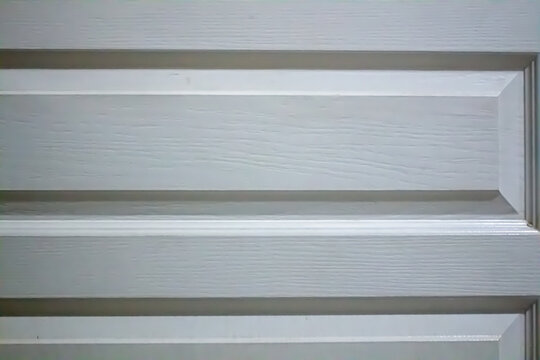 Close-up texture of a white painted wooden door panel with horizontal molding and subtle grain. Minimalist architectural background