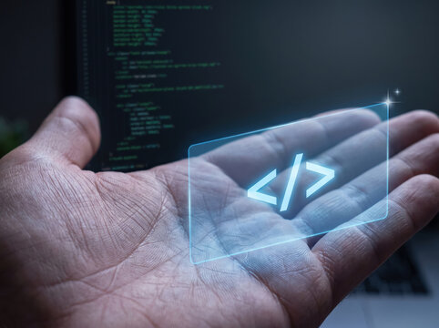 Hand interacting with digital code projection on screen