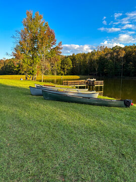 canoes on the shoreline of a small country pond in central Georgia USA.
