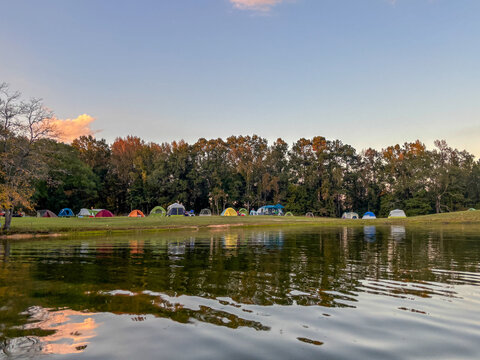 tent camping along lake or river campground in summer