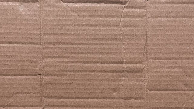 Stop Motion of Brown cardboard surface shows creases and folds. Useful background for design, branding, or industrial projects.