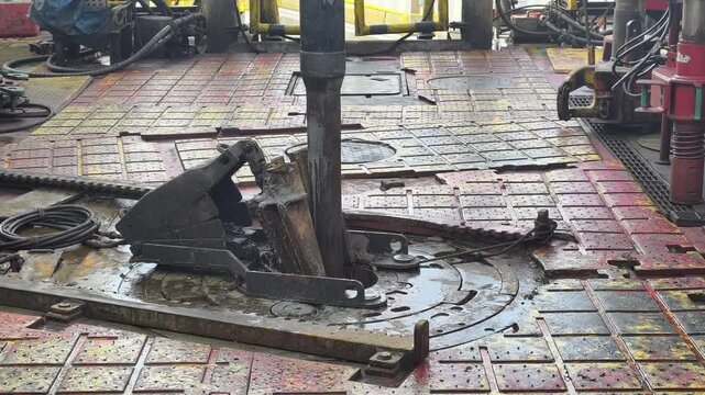 Drilling rig activity - Pull of of hole drill string with oil based mud on the rig floor. Trip out of hole.
