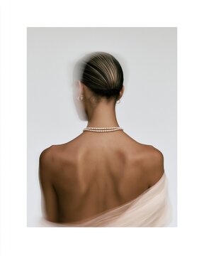 Back view portrait with pearl necklace and sheer drape