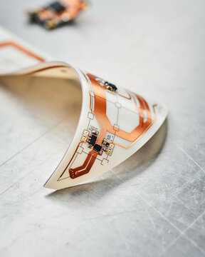 Flexible printed circuit board with copper traces and electronic components image photo