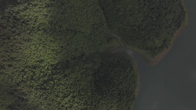 Aerial drone view of Ta Dung Lake surrounded by hundreds of green island hills and mountains in Ta Dung Commune, Lam Dong Province, Vietnam. View from QL 28. D Log mode