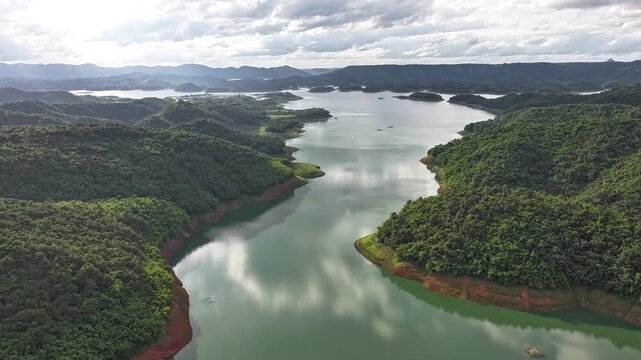 Aerial drone view of Ta Dung Lake surrounded by hundreds of green island hills and mountains in Ta Dung Commune, Lam Dong Province, Vietnam. View from QL 28. D Log mode