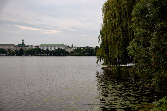 Panoramic view across the Au&szlig;enalster lake under a soft morning sky in Hamburg, Germany.