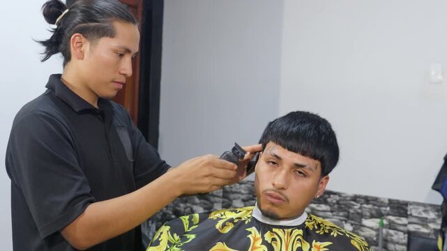 Barber giving a fade haircut with an electric clipper