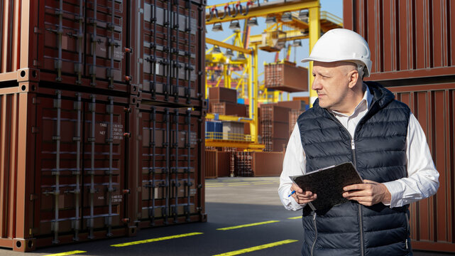 Container terminal logistics, supervisor inspects shipping containers and records cargo operations at a busy seaport container yard.
