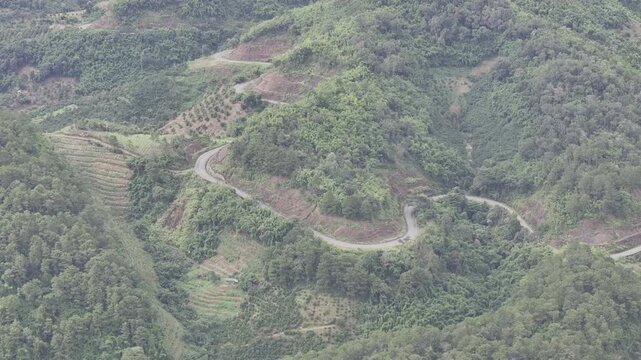 Aerial drone view of Ta Dung Lake surrounded by hundreds of green island hills and mountains in Ta Dung Commune, Lam Dong Province, Vietnam. View from QL 28. D Log mode