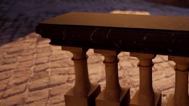 The image shows a close view of a railing made of four stone pillars placed on a cobblestone street. The light from the evening sun casts shadows, highlighting the texture of the stones.