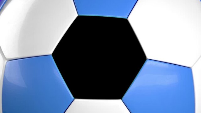 Soccer ball's intricate geometric pattern is revealed in a close-up view, highlighting its blue, white, and central black hexagonal and pentagonal panels.