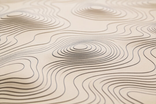 This image displays a smooth beige surface marked with concentric contour lines, forming a topographic pattern of gentle elevations and curves.