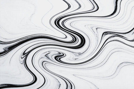 A monochrome abstract design featuring smooth swirling black lines on a white background, mimicking marble texture.