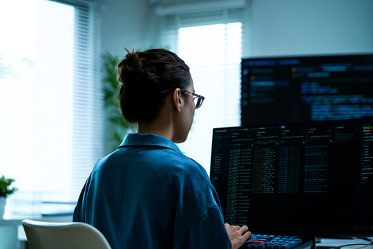Asian Female Software Engineer Coding on Multiple Monitors at Night Office. Software Development, Big Data Analytics, Women in Tech, Cyber Security, Remote Programming