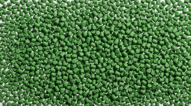 Macro shot of bright green polypropylene resin granules. Cylindrical polymer pellets create textured surface for plastic production and eco-friendly manufacturing. Raw material closeup.
