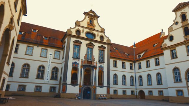 Historic baroque architecture of the former St. Mang Monastery in F&uuml;ssen, Bavaria, Germany, featuring an ornate courtyard and classical facade.