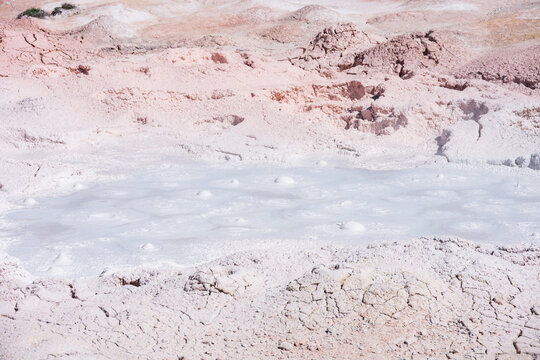Boiling pink mud of the Fountain Paint Pot mud pot, summer vacation at Yellowstone National Park viewing natural geothermal features
